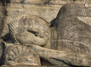 SRI LANKA, Polonnaruwa, Gal Vihara.  Mid twelth century reclining Buddha figure shown at the moment