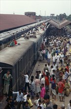 BANGLADESH, Bramanbahria, Train loaded with passengers in station with crowds on the platform and