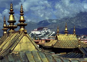 CHINA, Tibet, Lhasa, View from Jokhang Temple golden rooftops toward The Potala Palace in the