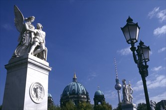 GERMANY, Berlin, Statues and street lamps on Schlossbrucke or Castle Bridge with the dome of the