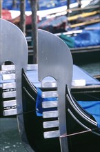 ITALY, Veneto, Venice, Close up view of elaborate prows of two moored gondolas
