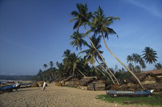 SRI LANKA, Tangalle, Fishing boats pulled up onto sandy beach of south coast fishing town and