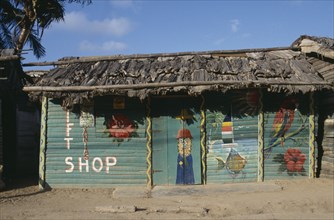DOMINICAN REPUBLIC, Architecture, Green thatched roadside shop with naive paintings on it
