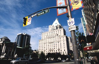 CANADA, Vancouver, Howe Street sign and traffic signal framing city architecture and Art Gallery on