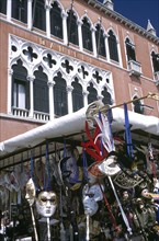 ITALY, Veneto, Venice, Street stall selling tourist masks with the Danieli Hotel behind