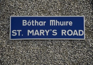 IRELAND, Donegal, Inishowen, Street name sign in Gaelic and English.