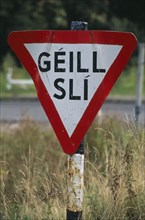 IRELAND, Donegal, Inishowen, Road sign in Gaelic.