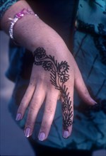 INDIA, General, Close up of womans hand decorated with Henna in preperation for a wedding