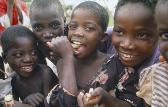 MALAWI, Lumbe, Young children eating sugar cane