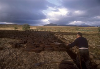 IRELAND, County Mayo, Agriculture, Peat cutter at work
