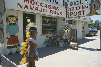 USA, Indigenous People, Native American Indian man and boy in costume outside Sioux and Navajo
