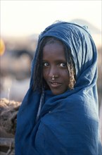 ETHIOPIA, People, Body Decoration, Girl in blue shawl with light facial scarification wearing a