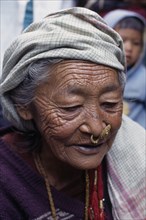 NEPAL, East, Dhankuta Region, Elderly Limbuni tribeswoman wearing traditional gold Limbu nose