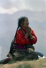 CHINA, Tibet, Drepung Monastery, Woman in prayer