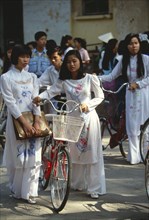 VIETNAM, North, Hanoi, Girls wearing the traditional ao dai outside their college