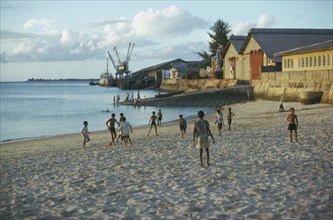 TANZANIA, Zanzibar Island, Boys playing football on the beach.