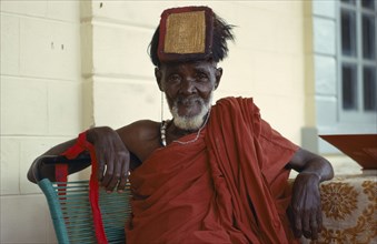GHANA, People, Ashanti tribal elder wearing gold head tablet to denote  status and power.