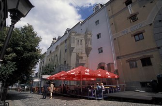 SERBIA, Belgrade, View of restaurant with red table umbrella’s in Skadarlija Pedestrian area.