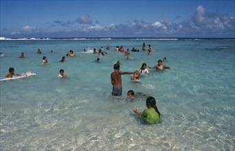 PACIFIC ISLANDS, Polynesia, Cook Islands, Atiu.  Girls swimming in the harbour.