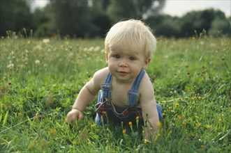 CHILDREN, Babies, One year old baby boy crawling on the grass