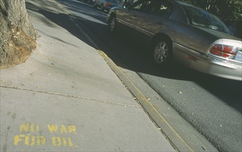 USA, New Mexico, Santa Fe, Anti Iraq war slogan painted on the pavement