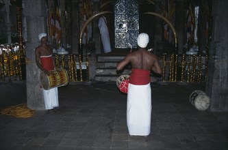 SRI LANKA, Kandy, Temple of the Tooth interior with drummers
