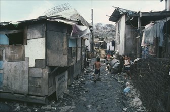 PHILIPPINES, Luzon Island, Manila, Smokey Mountain slum area.  Children in narrow alleyway between