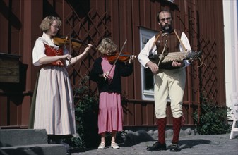 SWEDEN, Music, Folk musicians with woman and girl playing violins and man playing Nyckelharpa