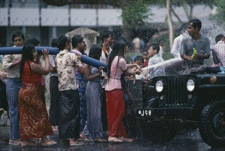 MYANMAR, Mandalay, Buddhist Water Festival.  Crowds spraying water from hose.