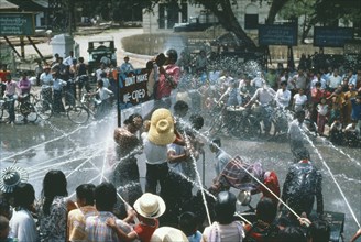 MYANMAR, Mandalay, Thingyan Buddhist Water Festival.  Crowds spraying water from hoses.