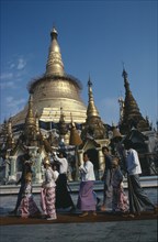 MYANMAR, Yangon, Shwedagon Pagoda.  Initiation of Buddhist novices at Shinpyu ceremony.