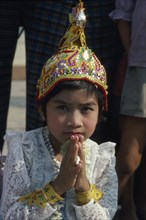 MYANMAR, Yangon, Shwedagon Pagoda.  Young girl in novice monk initiation ceremony