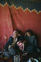 Qatar, Nomads, Bedouin children inside tent.