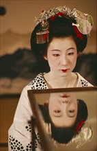 JAPAN, Kyoto, Portrait of a Geisha girl with reflection in a mirror