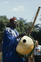 SENEGAL, Music, Manoinka musician playing the Kora which is a strung gouro instrument