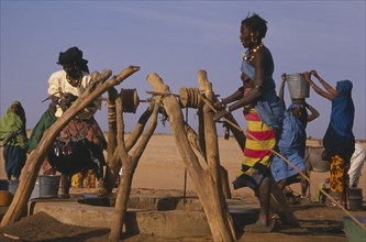 MALI, Sahara, Near Nampala, Fulani women drawing water at a well