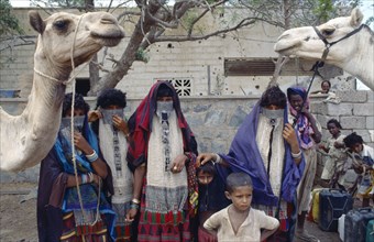 ERITREA, North West, Massawa, Rashaida nomad women and children with camels.