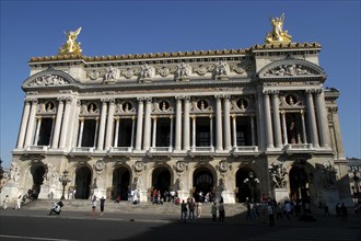 FRANCE, Ile de France, Paris, The Opera Garnier columned facade with golden statues atop