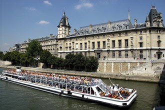 FRANCE, Ile de France, Paris, Open top tourist boat travelling down the River Seine