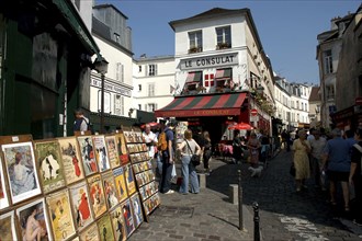 FRANCE, Ile de France, Paris, Posters for sale on a pedestrianized cobbled street