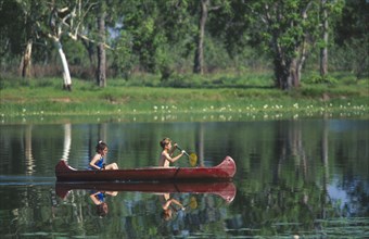 AUSTRALIA, Northern Territory, Children canoeing on Annaburroo Billabong near the Arnhem Highway at