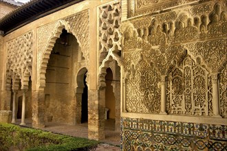 SPAIN, Andalucia, Seville, The Royal Alcazar interior courtyard view of decorative archway