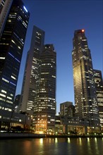 SINGAPORE, Raffles City, City skyline illuminated at dusk