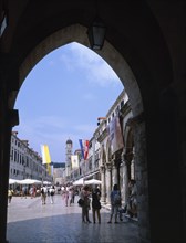 CROATIA, Dalmatia, Dubrovnik, View along flag lined street from archway of Ploce Gate