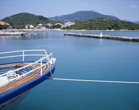 CROATIA, Dalmatia, Ston, Prow of a moored boat with coastline beyond