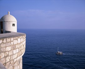 CROATIA, Dalmatia, Dubrovnik, Boat approaching City Wall or Gradske Zidine from the Adriatic Sea