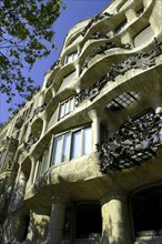 SPAIN, Catalonia, Barcelona, Angled view looking up at Gaudi apartment building Casa Mila