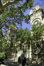 SPAIN, Catalonia, Barcelona, Angled view of the Barcelona Museum facade seen through trees