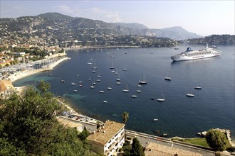 FRANCE, Cote d Azur, View over bay between Nice and Monte Carlo with moored Cruise ship and smaller