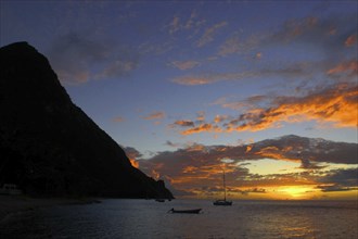 WEST INDIES, St Lucia, Sunset over the sea with passing boats seen from Jalousie Beach